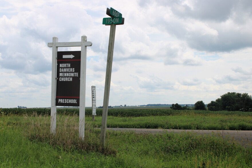 A sign sits in a empty field stating North Danvers Mennonite Church.