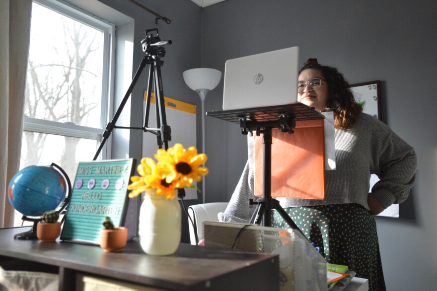 Walton Fellow Maria Martinez has decorated her virtual workspace at her home in Lawrence with the trappings of a real classroom.