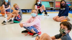 Fifth graders wear face masks are seated at proper social distancing spacing during a music class at the Milton Elementary School in Rye, N.Y. in this May 18, 2021 file photo.