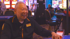 George Lee sits at a table and deals cards