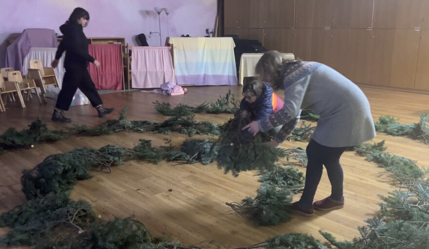 Left to right: Regan Dervaes, Shenandoah Herda and Ashley Mikos, all teachers at the Anchorage Waldorf School. They say the process of creating the spiral is very intentional, as they work together to create a pieces of living art.