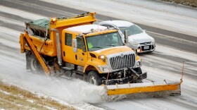 Missouri Department of Transportation snow plows drive east while treating ice and snow building up on Interstate 44 on Wednesday, Feb. 2, 2022 in St. Louis, Mo.