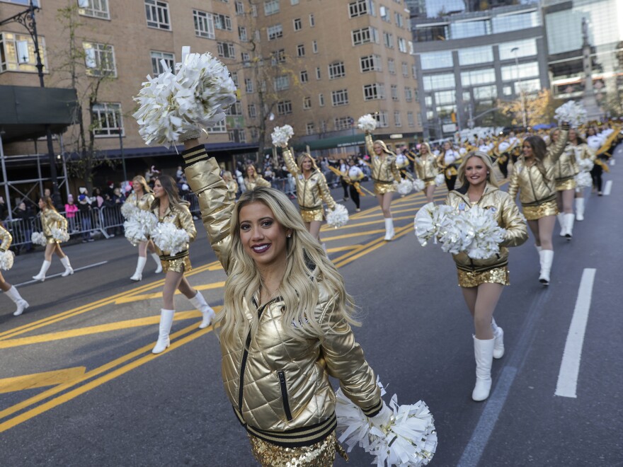 Cheerleaders from the University of Missouri marching band walk down Central Park South during the Macy's Thanksgiving Day Parade.