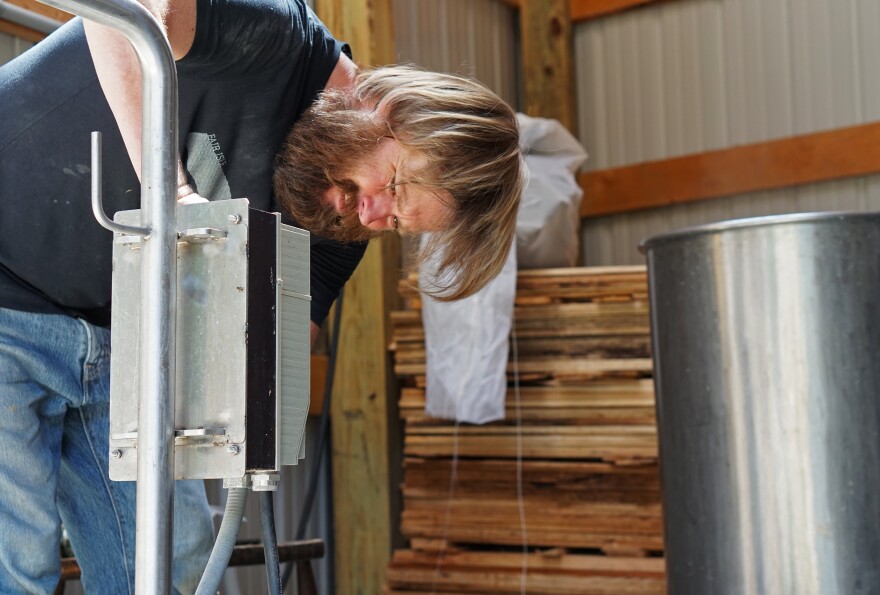 Aaron Kleidon, co-owner of Scratch Brewing Company, pumps the boiling, malty liquid through a cooling system before transferring it into a fermenter.