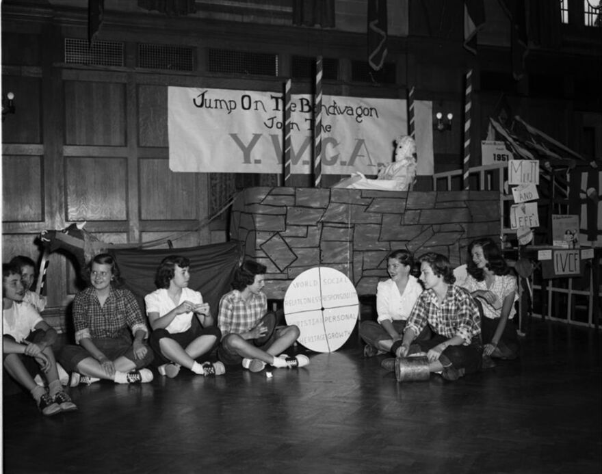 IU students sit in front of a makeshift "bandwagon" advertising IU's YWCA chapter in 1949.