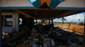 A Bahamian flag flies over a storm severely damaged by Hurricane Dorian in the Queen's Cove neighborhood of Freeport, Grand Bahama on September 17, 2019.