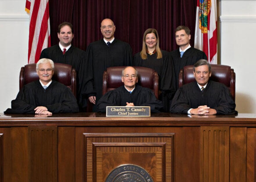 Supreme Court Justices seated for group photo.