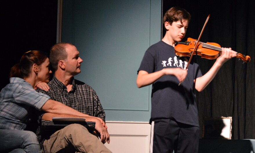 Kara Campbell, Kirsten Wylder, and husband James, Scott De Broux, look on at son Thomas, Robin Stricklin as he learns to feel the music.  