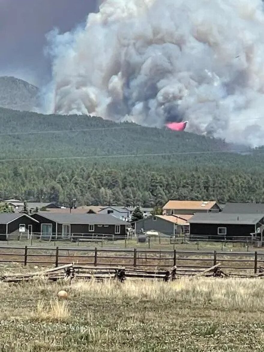 An air tanker drops fire retardant on the Pipeline Fire in the Fort Valley area of Flagstaff on June 12, 2022.
