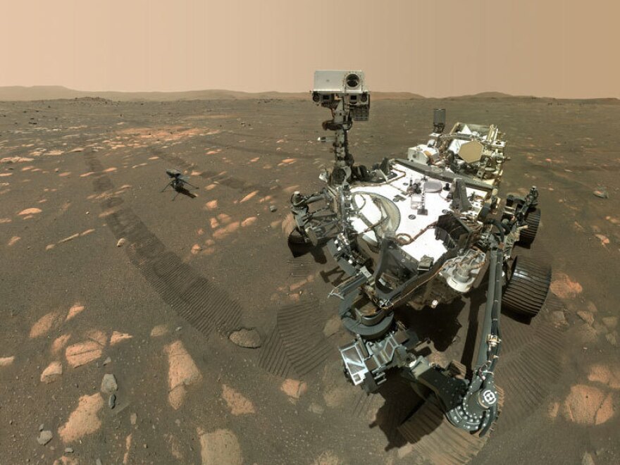 Perseverance takes a selfie with its helicopter companion Ingenuity in the background.