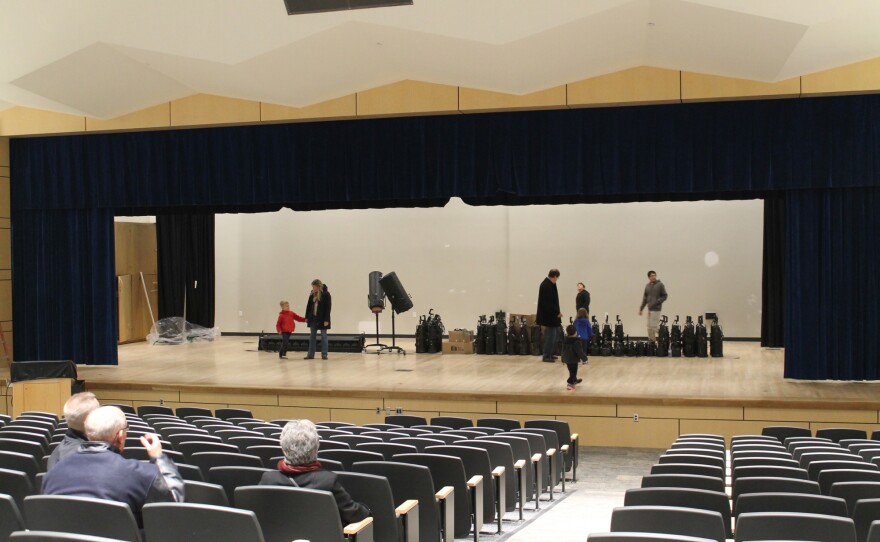 Community members tour the newly renovated south auditorium. A larger auditorium will be added in the next building phase.