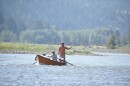 A drift boat with people fly fishing floats down the Yellowstone River, Friday, July 31, 2026, near Livingston, Montana.