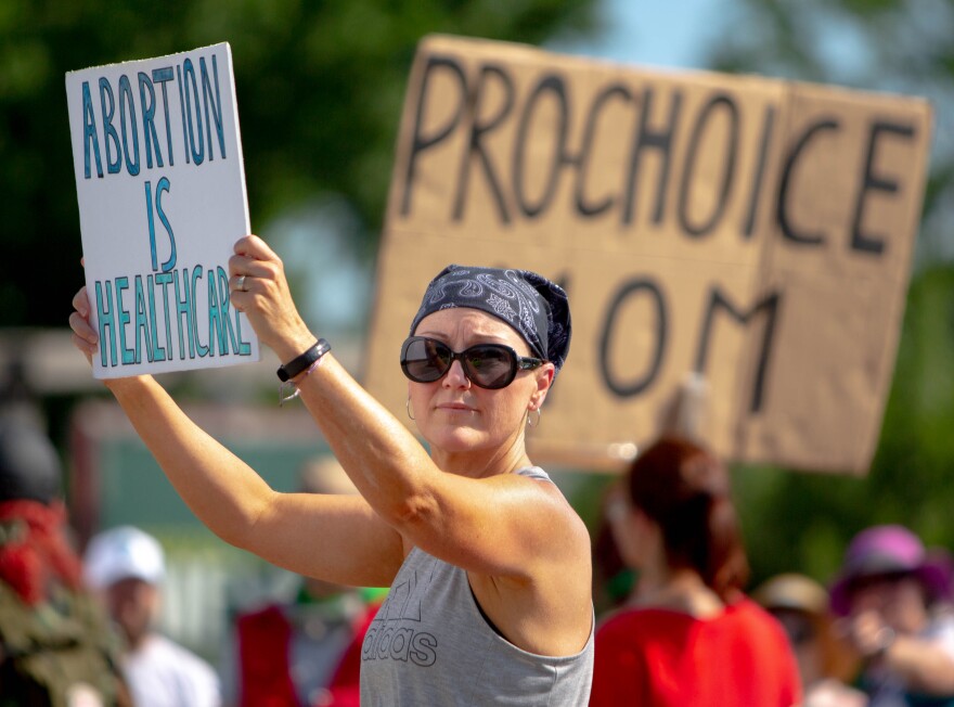 Tari Sanders, 49, of O’Fallon, Mo., protests a campaign event including Missouri Attorney General and Senate-hopeful Eric Schmitt and Sen. Ted Cruz (R-Texas), on Saturday, July 23, 2022, outside of Piazza Messina in Cottleville. 