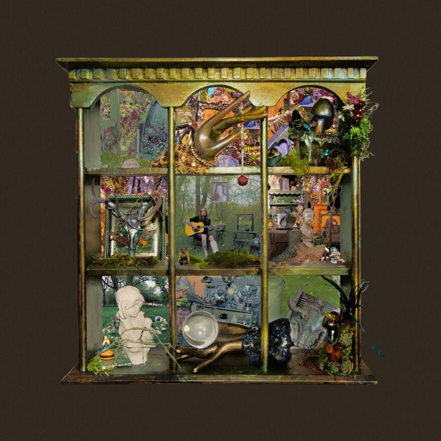 A brown background with a square in the middle depicting a tiny diorama with different 'rooms' in all nine boxes, with a musician sitting holding a guitar in the middle box.