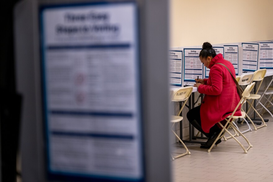 Voters cast their ballots on Super Tuesday at City Hall in San Francisco, Calif.