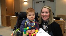Lindsey Topping-Schuetz poses for a photo with her three-year-old son Owen before testifying about the challenges families face in obtaining state-paid developmental disabilities services.