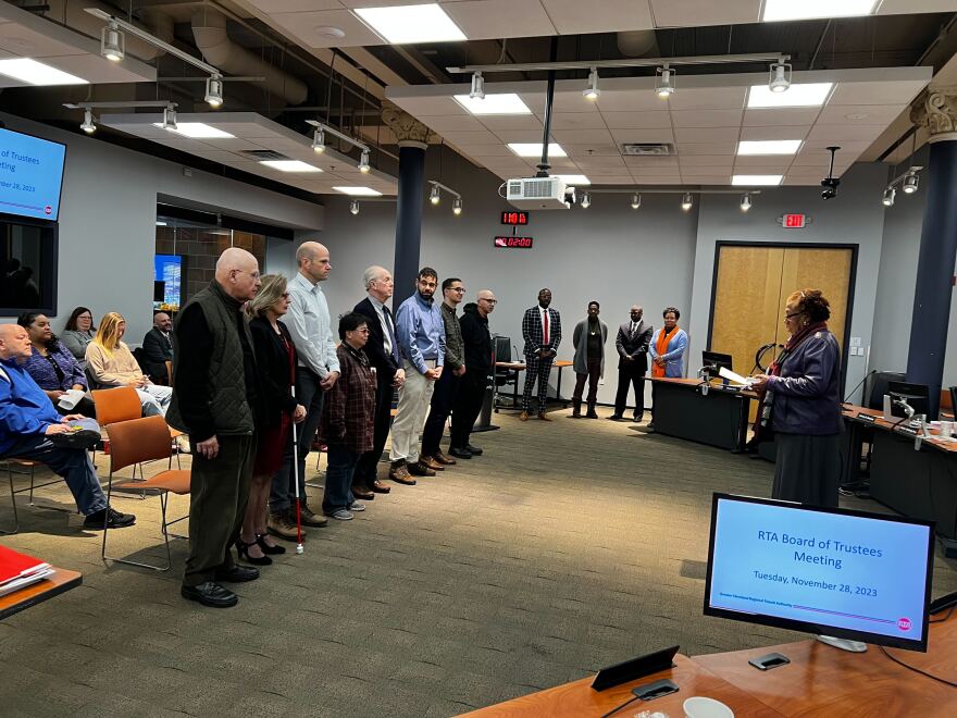 Members of the Community Advisory Committee stand in a line while being sworn in by GCRTA  Deputy General Manager of Legal Affairs Janet Burney. 