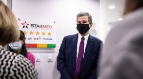 Gov. Roy Cooper greets employees at a StarMed clinic in Charlotte on Thursday, June 3.