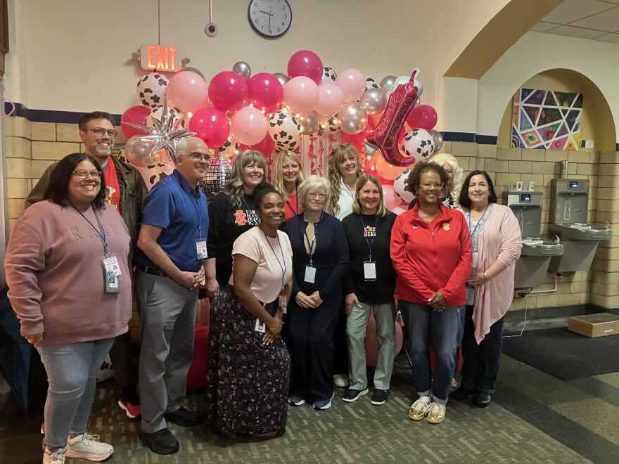 Longfellow School staff, Rock Island-Milan School District leaders and Board of Education members pose for a photo during "Dolly Day" Friday morning, Sept. 25 at the Rock Island elementary school.