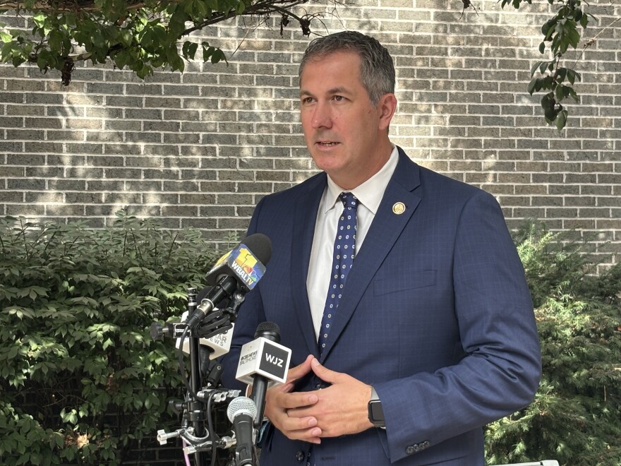 Rep. Johnny Olszewski speaks to reporters Monday about the government shutdown.