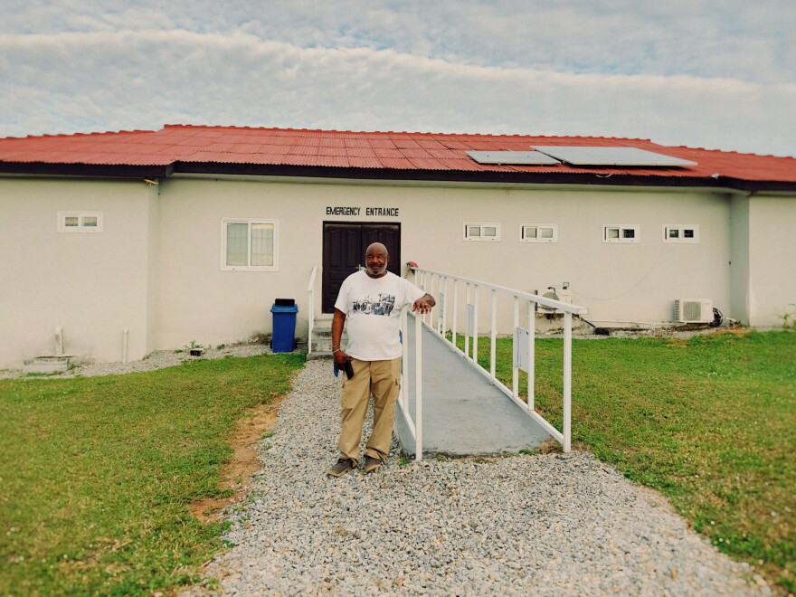 Nana Kofi outside the clinic he built with his daughter.