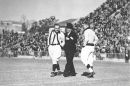 Former Louisiana governor Huey Long (center) walking arm in arm with a referee at Tiger Stadium during a football game