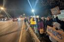 Protesters line Pattonwood Drive in Irondequoit near the U.S. Customs and Border Protection's Rochester border patrol station on Thursday, Jan. 8, 2026.