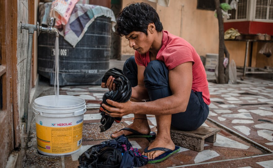 Neetu washes clothes in her rented room in Rohtak, India, where she lives (and trains) during the week. On weekends, she goes home to her village to be with her family.