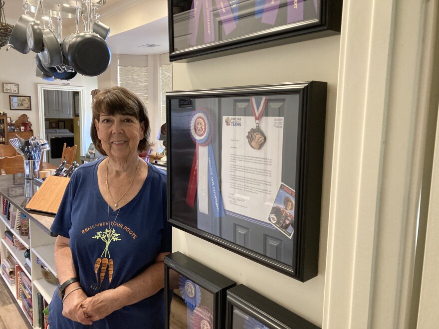 Sally Muhl poses with her 2021 best-in-show cooking competition ribbon from the State Fair of Texas .