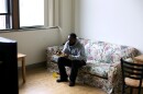 Quinton Reed eats a home cooked lunch and watches TV at his Garfield Commons Apartment. Reed was diagnosed with schizophrenia after years of struggling with homelessness.