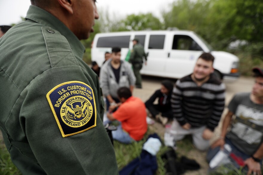 A Border Patrol agent talks with a group suspected of having entered the U.S. illegally near McAllen on March 14.