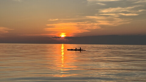A pair of boaters at sunset on July 10, 2026, on Lake Ontario near Webster, New York.