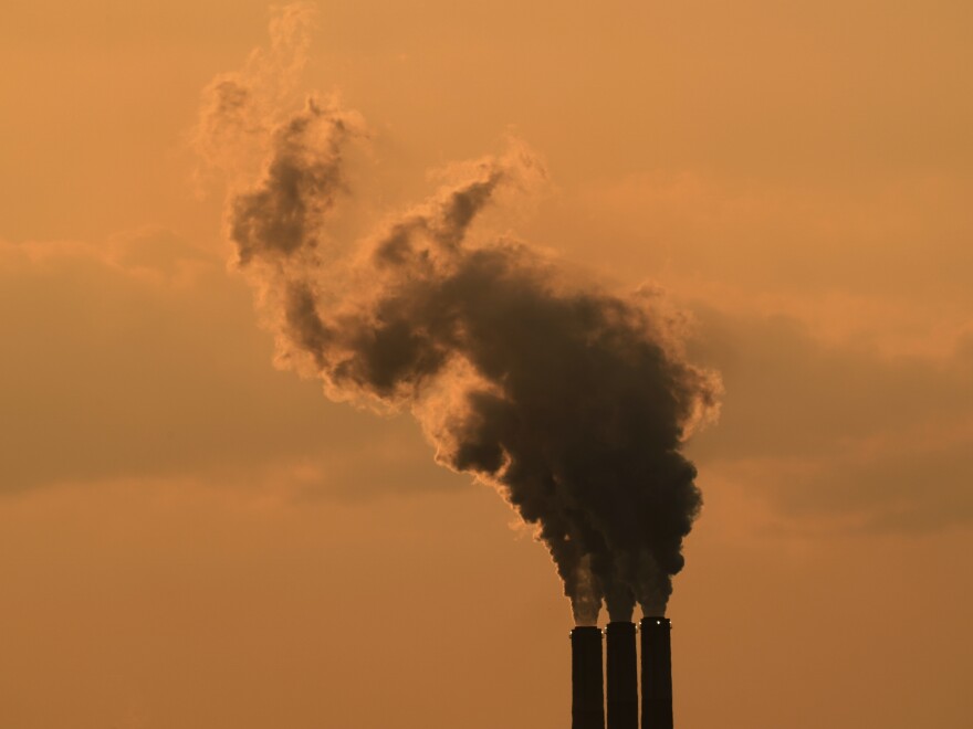 Smokestacks at the Jeffrey Energy Center coal-fired power plant are silhouetted against the sky at sunset in September near Emmet, Kan.