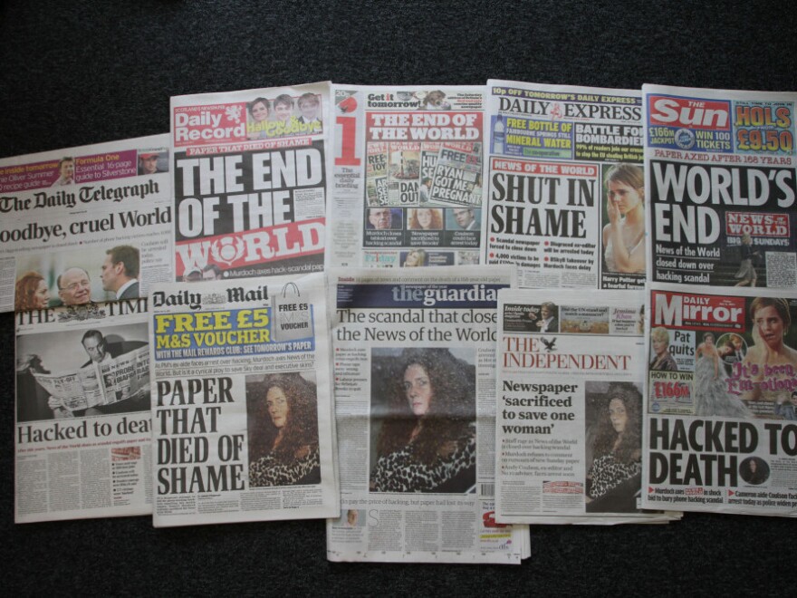 Various front pages of London newspapers report on the closing of the national tabloid newspaper <em>News of The World</em> in London, England.