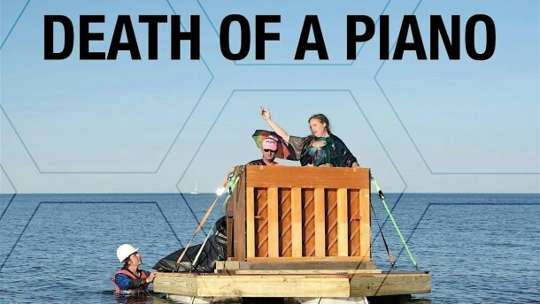 Poster for "Death of a Piano" a film by Tomas Soderberg; photo of two people on a makeshift raft performing with a piano, one person in the water with a hard hat
