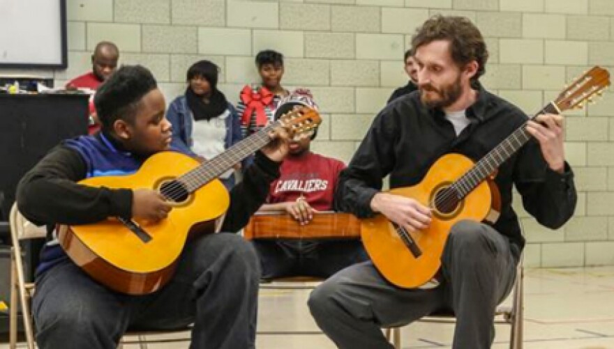 Damian Goggans (left) performs with Cleveland Classical Guitar Society director of education Brian Gaudino