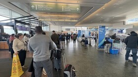 Air travelers wait for TSA PreCheck at Ted Stevens Anchorage International Airport in a line that stretches past the Alaska Airlines baggage drop area on Thursday, May 21, 2026.
