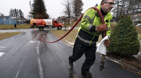 Daniel DiDonato, a deliveryman for Heatable, brings heating oil to a home in Lewiston, Maine, Thursday, Dec. 16, 2021.