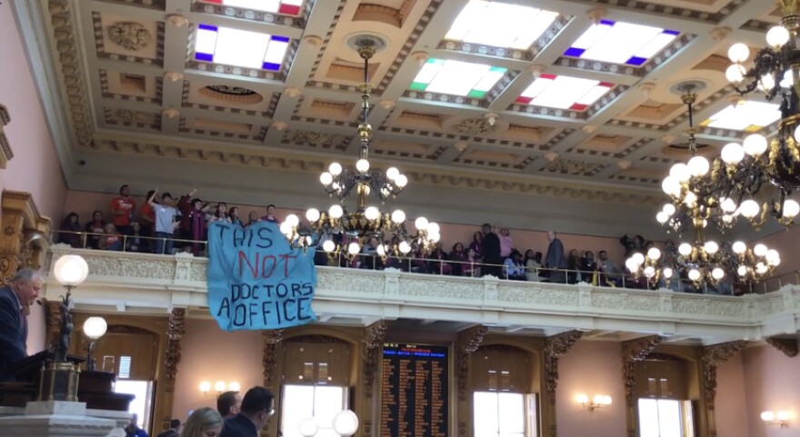 Abortion advocates unfurl banner as Ohio House passes abortion restrictions