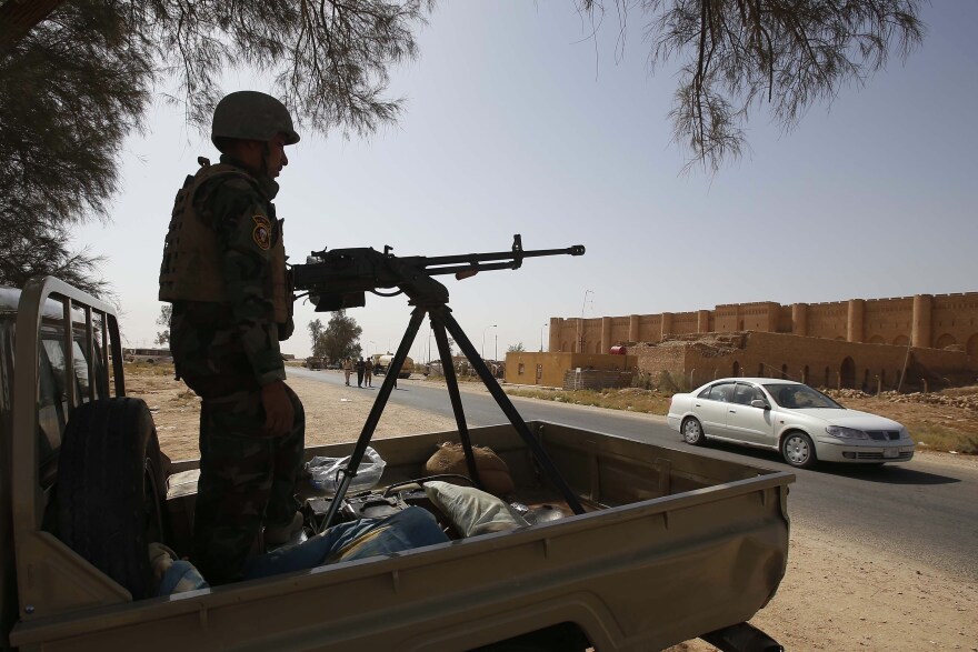 An Iraqi soldier monitors a street west of the shrine city of Karbala, in central Iraq on Sunday.