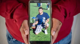 A photograph of a Victor man detained by ICE earlier this month is held by the man's wife in their Teton Valley home.