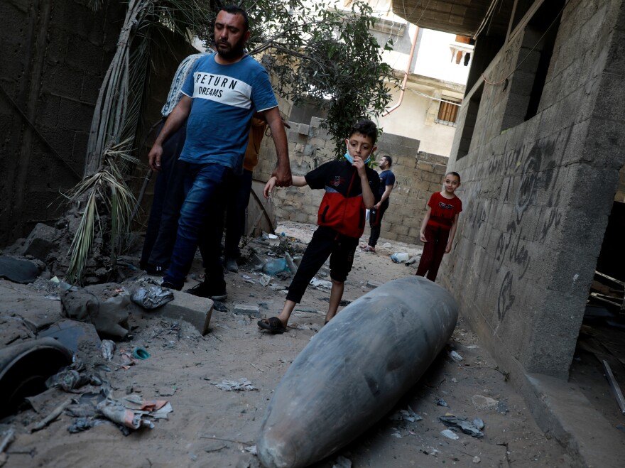 Palestinians look at an unexploded bomb dropped by an Israeli F-16 warplane on Gaza City's Rimal neighbourhood on Tuesday.