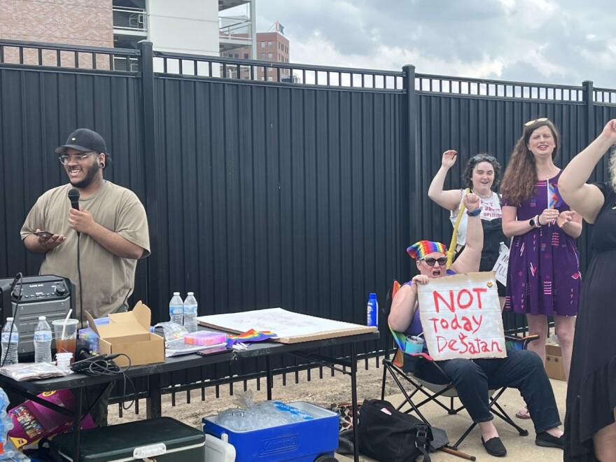 Organizer and Peorians for Black Liberties co-founder Marshall Seidel (left) speaks to protesters outside the Peoria Civic Center on Friday.