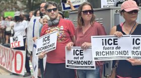 Protesters hold signs outside Richmond City Hall on Aug. 11, 2025, during a rally against recent Immigration and Customs Enforcement (ICE) detentions, calling for the city to bar local cooperation with federal immigration authorities.