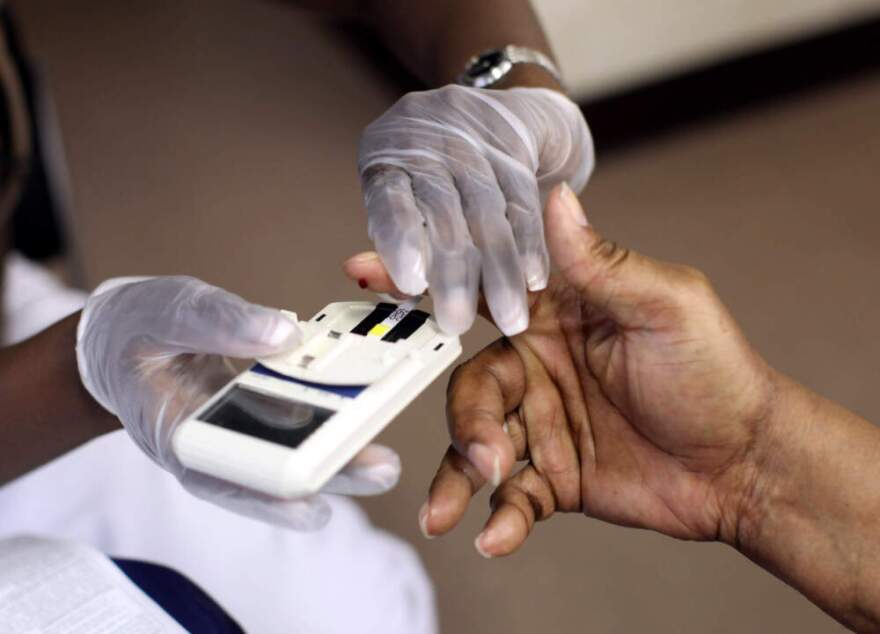 A mans finger is pricked to test his cholesterol at the City of Newark's free homeless health fair in Newark, New Jersey. (Rick Gershon/Getty Images)