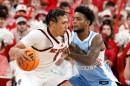 FILE - North Carolina State's Darrion Williams (1) tries to drive the ball around North Carolina's Jaydon Young (4) during the second half of an NCAA college basketball game in Raleigh, N.C., Feb. 17, 2026.