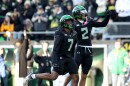 Oregon defensive back Ify Obidegwu (7) celebrates with defensive back Kingston Lopa (2) after his interception during the first half of an NCAA college football game against Southern California, Saturday, Nov. 22, 2025, in Eugene, Ore. (AP Photo/Lydia Ely)