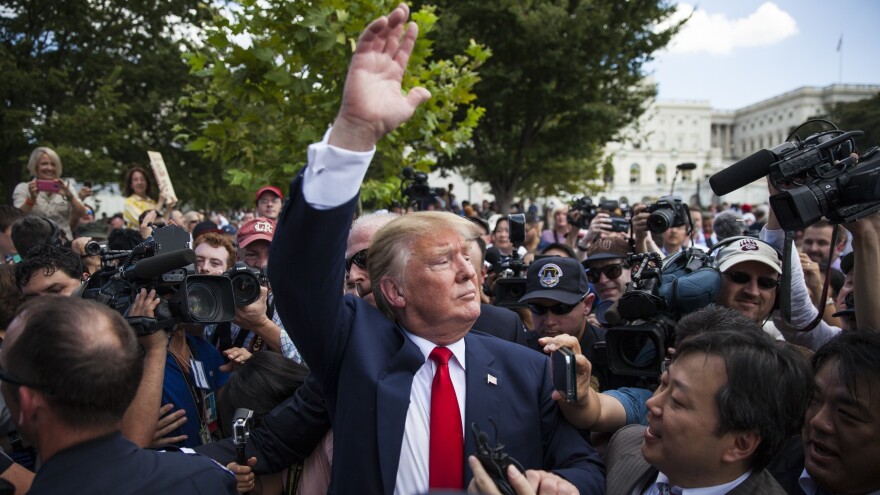 Trump waives to supporters at a Tea Party in Washington in September 2015. "For the first time our people are in the room, you know?" says a Tea Party leader.