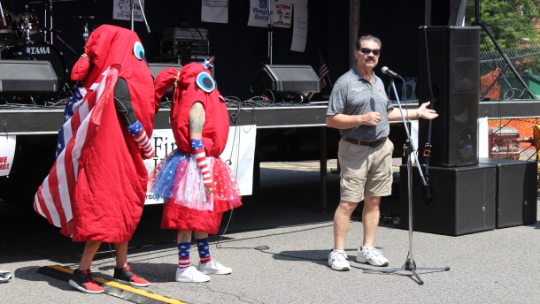 Plymouth Mayor Frank Coughlin givens opening remarks at the Plymouth Alive Kielbasa Festival beside Mr. and Mrs. Kielbasa.