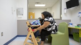 In this file photo, a mother and her son await a session at the Marcus Autism Center in Atlanta, GA. North Carolina officials have released a comprehensive plan to address a "critical shortage" of support professionals for those with disabilities. (DAVID GOLDMAN/AP)